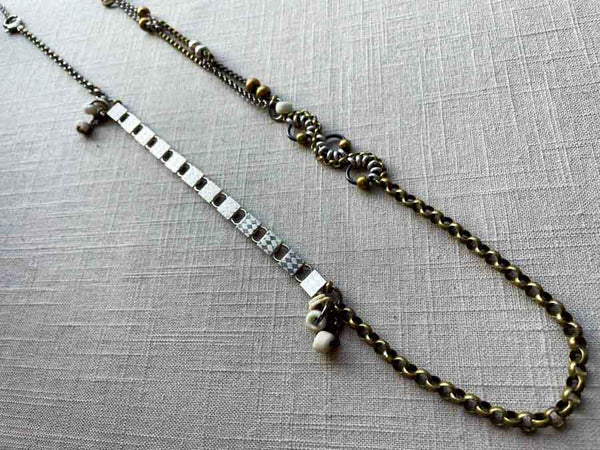 top view of fragment chain necklace with vintage and reclaimed chain elements and various trade beads