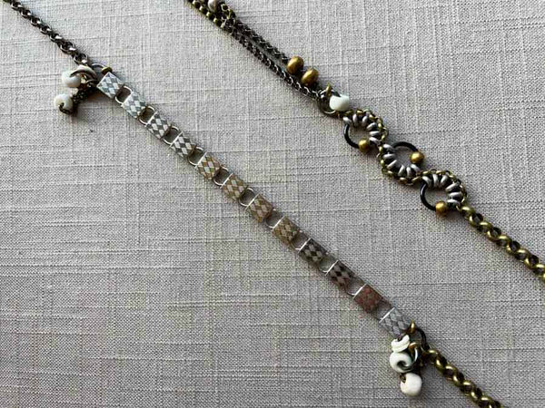 closeup of fragment chain necklace with vintage and reclaimed chain elements and various trade beads