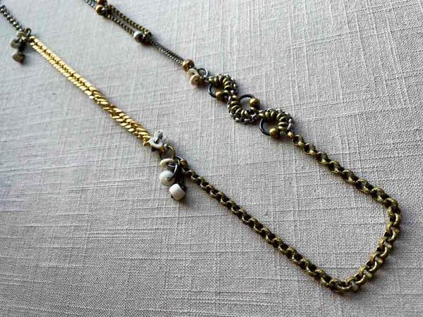 top view of fragment chain necklace with vintage and reclaimed chain elements and various trade beads