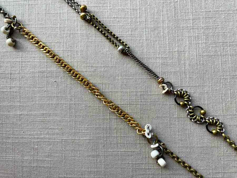 closeup of fragment chain necklace with vintage and reclaimed chain elements and various trade beads