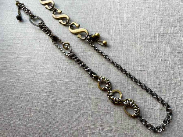 top view of fragment chain necklace with vintage and reclaimed chain elements and various trade beads