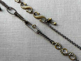 closeup of fragment chain necklace with vintage and reclaimed chain elements and various trade beads