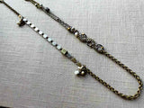 top view of fragment chain necklace with vintage and reclaimed chain elements and various trade beads