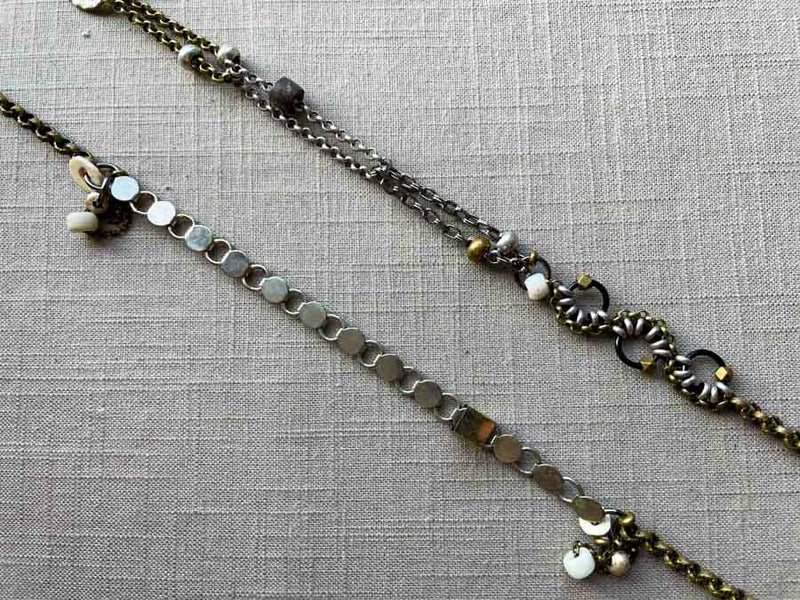 closeup of fragment chain necklace with vintage and reclaimed chain elements and various trade beads