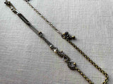 top view of fragment chain necklace with vintage and reclaimed chain elements and various trade beads