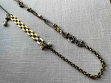 top view of fragment chain necklace with vintage and reclaimed chain elements and various trade beads