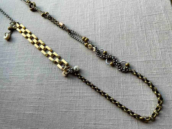 top view of fragment chain necklace with vintage and reclaimed chain elements and various trade beads