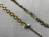 closeup of fragment chain necklace with vintage and reclaimed chain elements and various trade beads