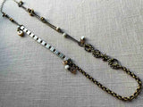 top view of fragment chain necklace with vintage and reclaimed chain elements and various trade beads