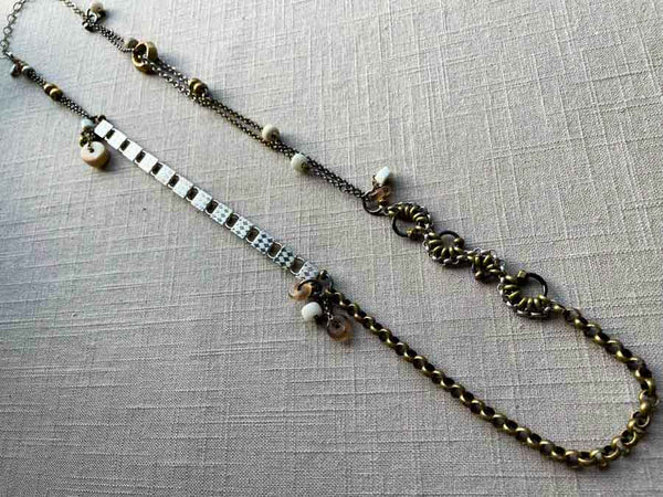 top view of fragment chain necklace with vintage and reclaimed chain elements and various trade beads