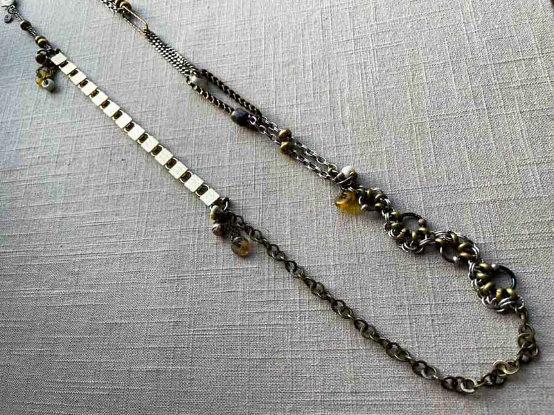 top view of fragment chain necklace with vintage and reclaimed chain elements and various trade beads