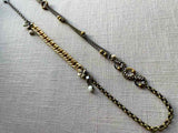 top view of fragment chain necklace with vintage and reclaimed chain elements and various trade beads