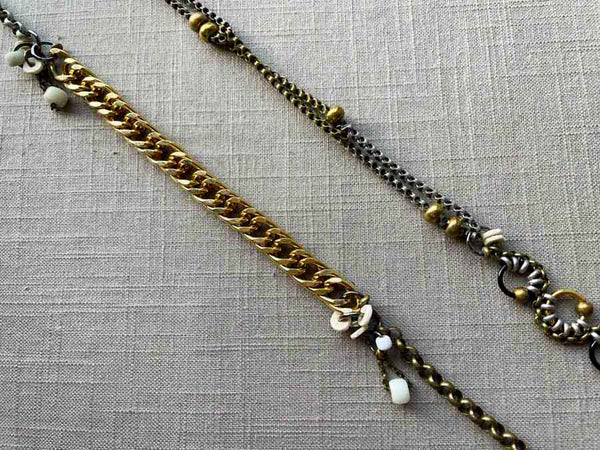 closeup of fragment chain necklace with vintage and reclaimed chain elements and various trade beads