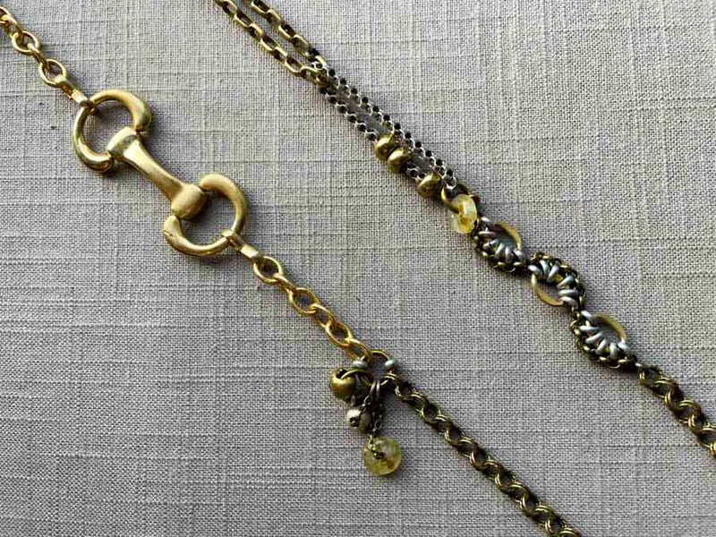 closeup of fragment chain necklace with vintage and reclaimed chain elements and various trade beads