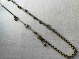 top view of fragment chain necklace with vintage and reclaimed chain elements and various trade beads