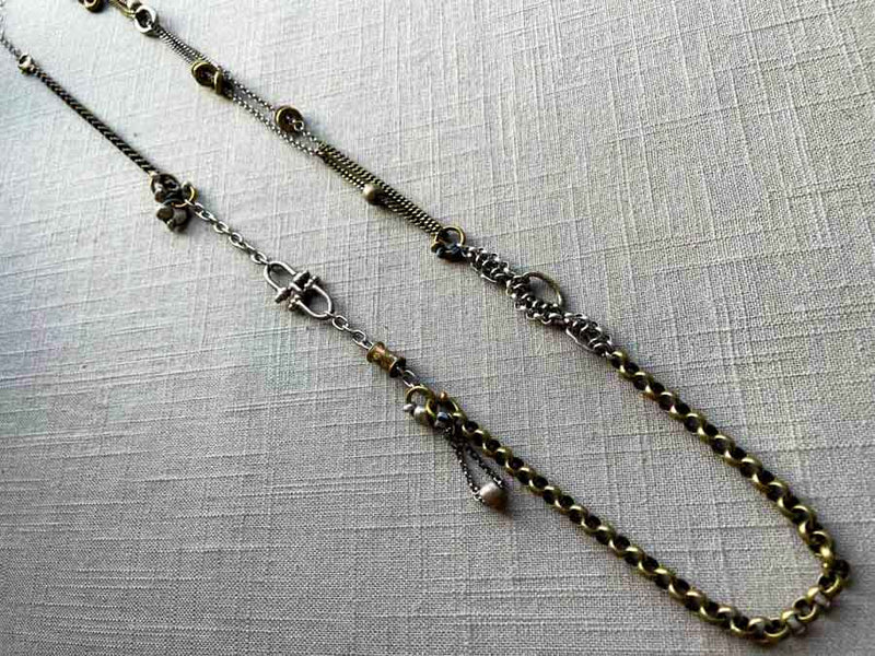 top view of fragment chain necklace with vintage and reclaimed chain elements and various trade beads