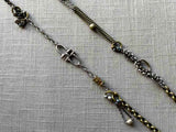 closeup of fragment chain necklace with vintage and reclaimed chain elements and various trade beads