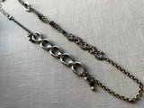 top view of fragment chain necklace with vintage and reclaimed chain elements and various trade beads