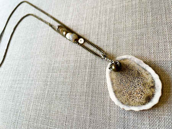 top view of antler slice necklace on bronze-plate reclaimed chain