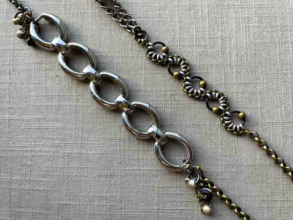 closeup of fragment chain necklace with vintage and reclaimed chain elements and various trade beads