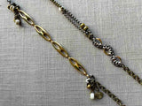 closeup of fragment chain necklace with vintage and reclaimed chain elements and various trade beads