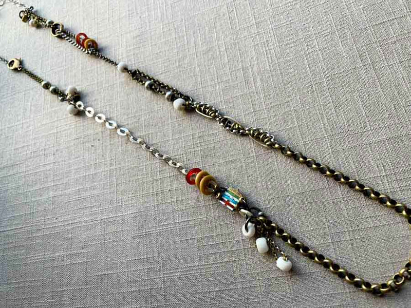 top view of fragment chain necklace with vintage and reclaimed chain elements and various trade beads