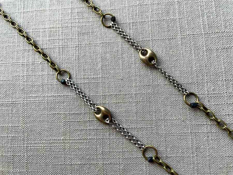 closeup of mariner link necklace with mixed metal chain pattern