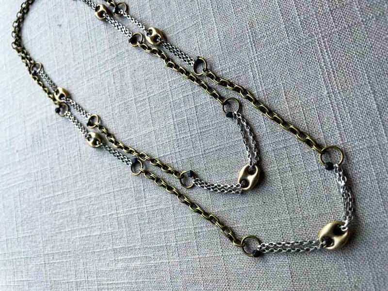 top view of mariner link necklace with mixed metal chain pattern