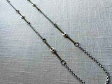 top view of mariner link necklace with mixed metal chain pattern