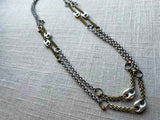 top view of mariner link necklace with mixed metal chain pattern