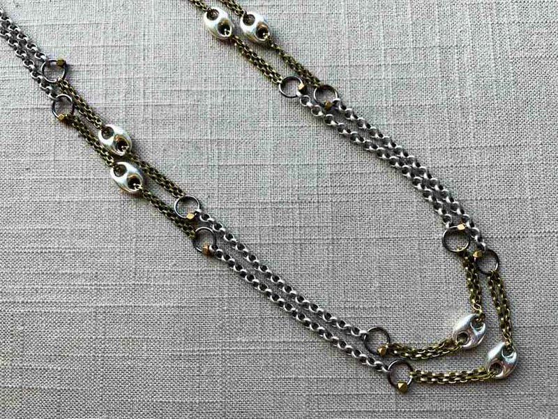 closeup of mariner link necklace with mixed metal chain pattern