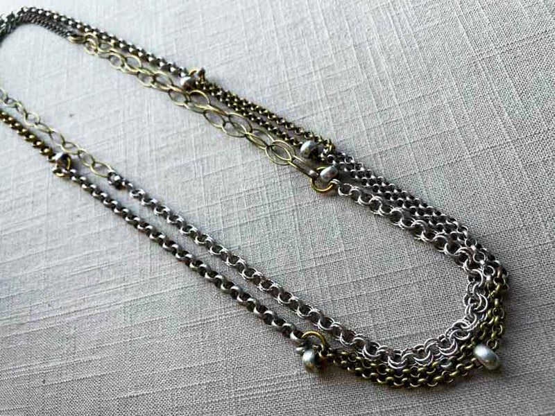 top view of 64"L mixed metal chain necklace with silver beads