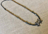 top view of pave horse pendant hung on metallic bead choker