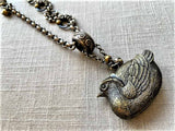 side view of bird match safe pendant on chain mix