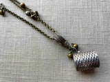 closeup of antique sterling silver thimble holder on chain mix