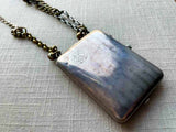 closeup of antique sterling silver compact/change holder/notepad on chain mix