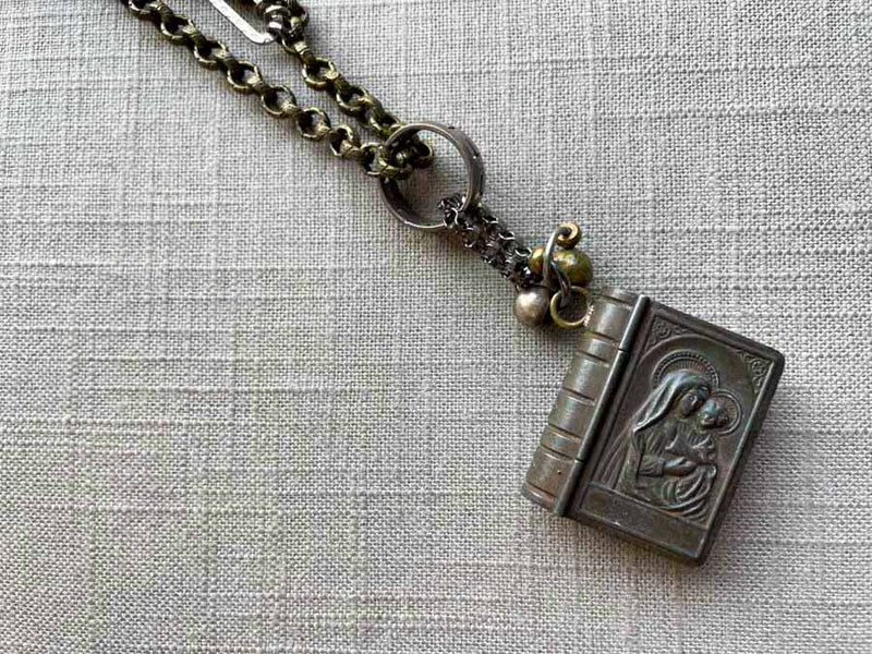 closeup of antique rosary box pendant on chain mix 