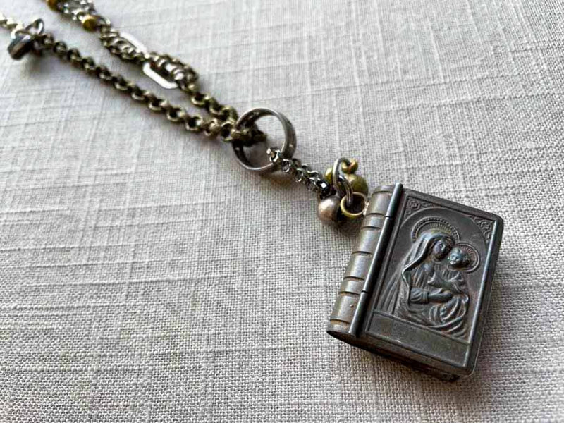 closeup of antique rosary box pendant on chain mix