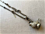 top view of antique tin salt shaker (bird) pendant on chain mix