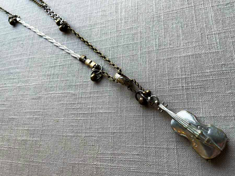 top view of antique sterling silver cello pendant on chain mix