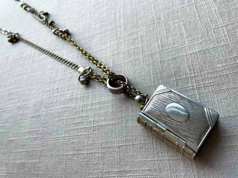 top view of antique sterling silver match safe (book) pendant on chain mix