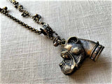 closeup of antique bronze match safe (bulldog) pendant on chain mix