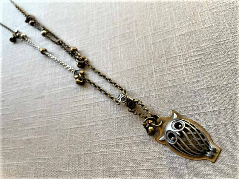 top view of antique owl pendant on chain mix