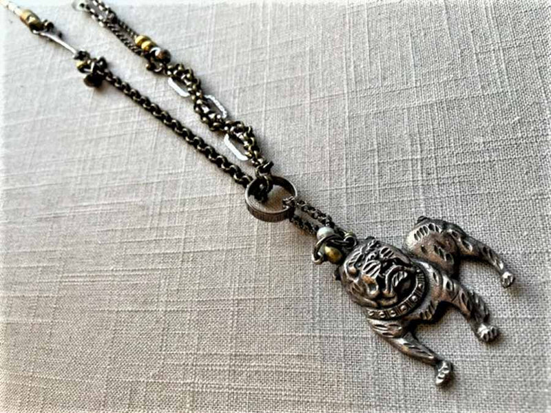 top view of antique sterling silver bulldog pendant on chain mix