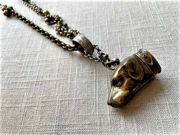 closeup of antique bronze match safe pendant on chain mix