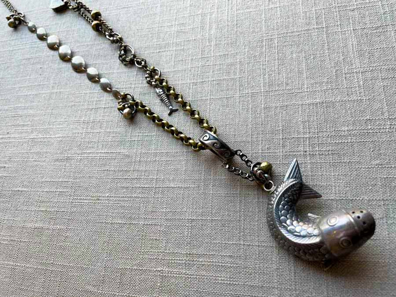 top view of antique sterling silver fish salt shaker pendant on chain mix