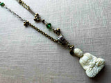 top view of antique carved buddha pendant on chain mix