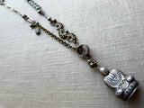 top view of antique sterling silver buddha salt shaker pendant on chain mix