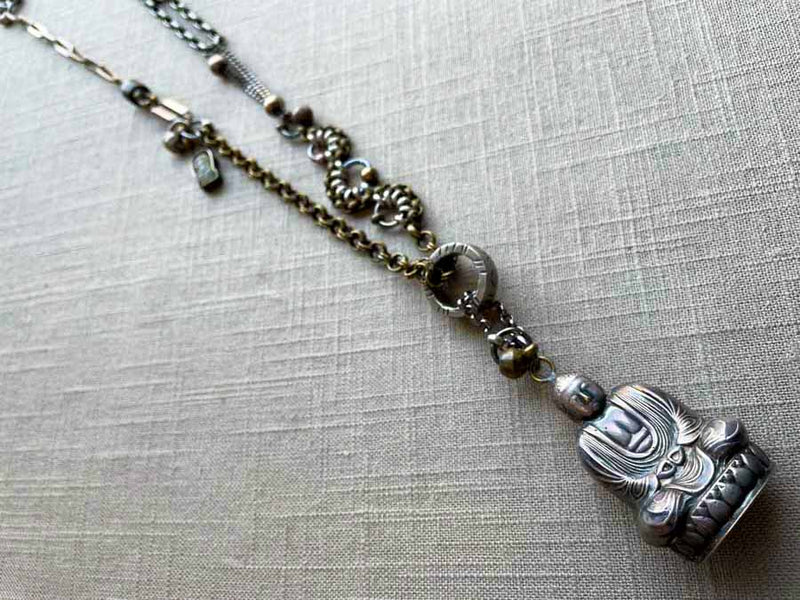 top view of antique sterling silver buddha salt shaker pendant on chain mix