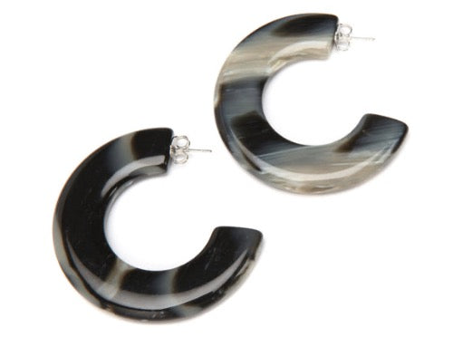 top view of resin earrings in black and white